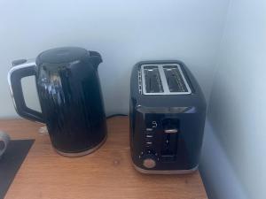 a toaster and a coffee maker sitting on a table at The Avenues Hideaway in Tauranga