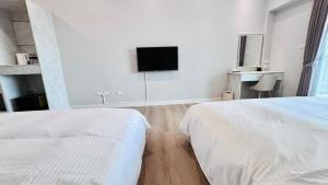 Voodi või voodid majutusasutuse Hello inn 哈囉行旅屏東館 toas