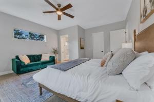 a bedroom with a large bed and a green couch at Fairway Luxury Mountain Retreat in Williams
