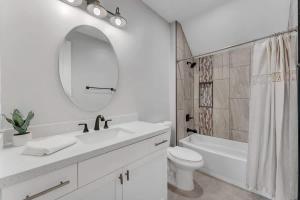 a white bathroom with a sink and a toilet and a mirror at Cozy Studio Space in Williams in Williams
