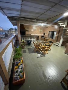 a room with chairs and a table on a building at Hostel Anprado 4 kit café incluso, Próx-Aeroporto de Guarulhos in Guarulhos