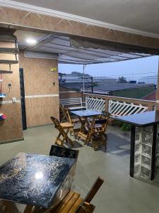 a patio with tables and chairs on a roof at Hostel Anprado 4 kit café incluso, Próx-Aeroporto de Guarulhos in Guarulhos