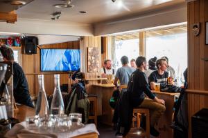 a group of people sitting at a bar at Eiger Chalet in Perisher Valley