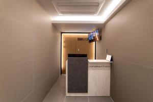 a hallway with a lobby with a sign on the ceiling at Stayz437 Jongno in Seoul +96 photos