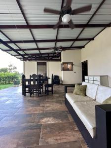 a living room with a couch and a ceiling fan at Trébol House in Cuatro Esquinas