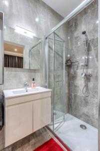 a bathroom with a sink and a shower at Luxury Cosy 3 Bedroom Apt in Gzira, close to Sliema StJulians by walk in Il-Gżira +31 photos