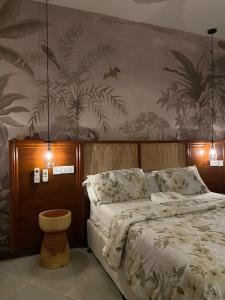 a bedroom with a bed and a wall with plants at makazi yetu - Makongo Area 4 in Dar es Salaam