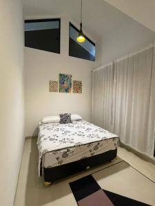 a bedroom with a bed in the corner of a room at Dirumahjogja - Villa 2 in Jarakan