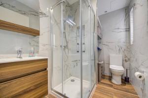 a bathroom with a shower and a toilet at Beautiful 2 BDR Penthouse near Valletta sleeps 6 in Il-Ħamra +12 photos
