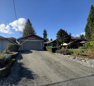a house with a garage on the side of a road at Deluxe Suite near Microsoft in Bellevue