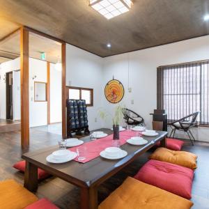 a dining room with a wooden table and chairs at Tokyo Ninja 屋敷 in Tokyo