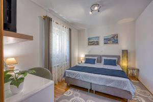 Ένα ή περισσότερα κρεβάτια σε δωμάτιο στο Apartments Jakara