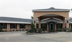 a large building with an archway in a parking lot at Americas Best Value Inn Caldwell in Caldwell