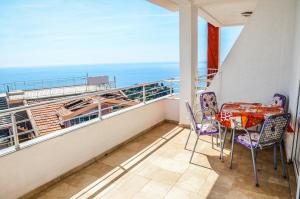 a balcony with a table and chairs and the ocean at Apartments Monte in Ulcinj
