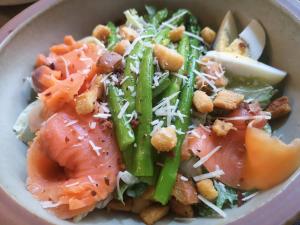 a bowl of food with salmon and vegetables and cheese at Cachet Boutique Kunming Artime in Kunming