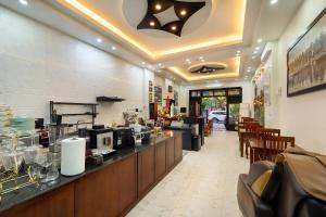 a restaurant with a counter with aasteryasteryasteryasteryasteryasteryasteryasteryastery at Golden Bell Homestay in Hoi An