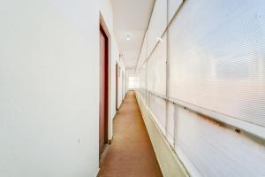 a corridor of an empty room with a window at Super Collection O Bannergatta Road Near Decathlon in Bengaluru
