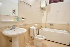 a white bathroom with a sink and a toilet at Sea & Mountain by Kim in Ha Long +59 photos
