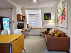 a living room with a couch and a table at Eco Gallery Apartment in Fremantle