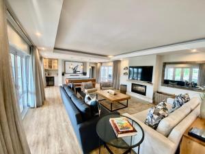 a living room with a couch and a table at Thesen Island Villas in Knysna