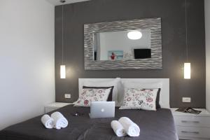 a bedroom with a bed with a laptop on it at Violeta Hvar in Hvar