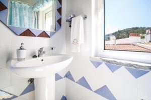 a bathroom with a sink and a mirror at Casa Morais in Odeceixe +21 photos
