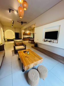 a living room with a wooden table and chairs at AYAAN SNOOKERS HOUSE at QUINTET FREE PARKING and NETFLIX in Tanah Rata +11 photos