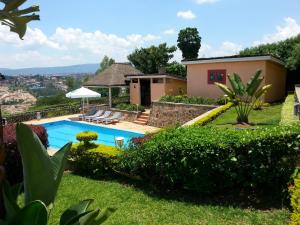 a house with a swimming pool in a yard at Villa Belle Vue in Kigali