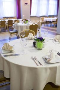 a table with white table cloths and wine glasses on it at Hotel Przedwiośnie in Masłów
