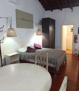 a room with two beds and a table in a room at Casita B in Asuncion