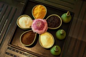 a group of bowls filled with different spices and apples at Lynnaya Urban River Resort in Siem Reap
