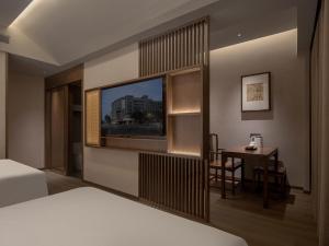 Krevet ili kreveti u jedinici u okviru objekta Chengdu Jianshantang Hotel Kuanzhai Alley Branch