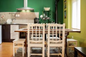 a kitchen with a table and chairs in a kitchen at La Casa De Luarca in Luarca