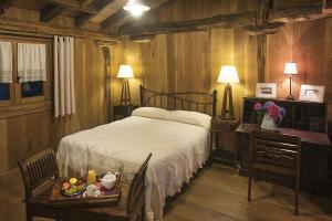 a bedroom with a bed and a table with a tray of fruit at Casa Rural Haritzpe in Hondarribia