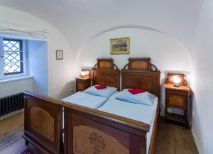a bedroom with two beds and two night stands at Zámecké apartmány Litomyšl in Litomyšl