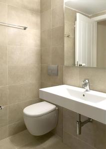 a bathroom with a toilet and a sink at Aria Monte Villas in Raches