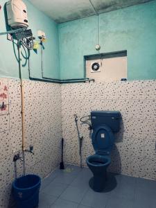 a bathroom with a toilet and a camera in it at Hello entire villa varkala cliff in Varkala