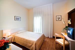 Łóżko lub łóżka w pokoju w obiekcie Hotel B&B Risorta