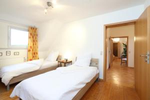 Ένα ή περισσότερα κρεβάτια σε δωμάτιο στο Ferienwohnungen Grafenfelder Hof
