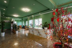 a room with green walls and potted plants at Bee Luxury Dalat Hotel in Xuan An