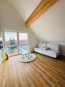 a living room with a bed and a table in a room at Pension Romantica, Appartment Diana in Rust