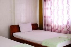 Postel nebo postele na pokoji v ubytování Lucky Hội an Hotel