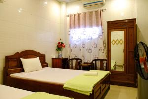 Postel nebo postele na pokoji v ubytování Lucky Hội an Hotel