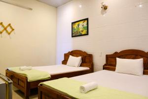Postel nebo postele na pokoji v ubytování Lucky Hội an Hotel