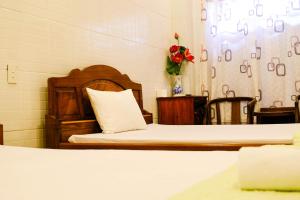 Postel nebo postele na pokoji v ubytování Lucky Hội an Hotel