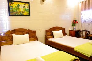 Postel nebo postele na pokoji v ubytování Lucky Hội an Hotel