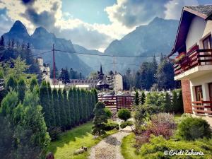 a view of a town with trees and a mountain at Villa Ermitage in Buşteni
