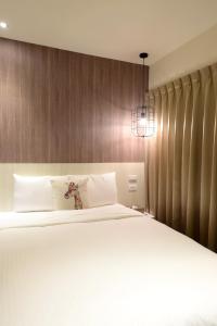 Postel nebo postele na pokoji v ubytování Ark Hotel - Changan Fuxing方舟商業股份有限公司