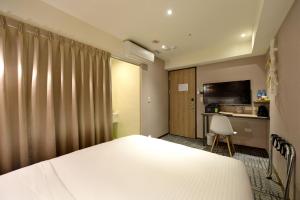 Postel nebo postele na pokoji v ubytování Ark Hotel - Changan Fuxing方舟商業股份有限公司