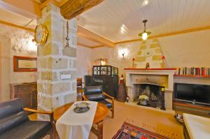 a living room with a table and a fireplace at Lilyum Alaçatı - Taş Ev in Alacati